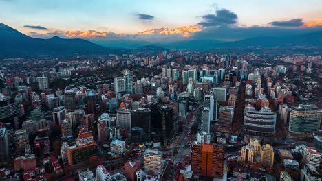 Aerial-Hyperlapse-Fly-Santiago-de-Chile-City-Panorama-Andean-Mountain-Sunset-at-El-Golf-neighborhood-background