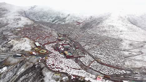 Drone-view-of-the-Buddhist-Academy-located-in-Larung-Gar,-Sertar-County,-Sichuan,-which-is-on-the-border-between-China-and-Tibet