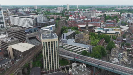 Newcastle-cityscape-with-buildings,-roads,-and-greenery,-aerial-view