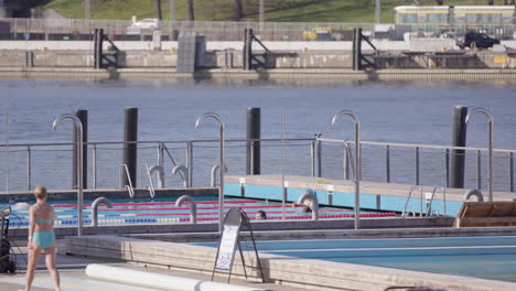 Telephoto-view-of-people-swimming-at-Allas-Sea-Pool-area-and-saunas-in-Helsinki