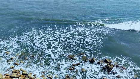 Aerial-view-of-waves-breaking-over-rocky-coastline,-Full-HD