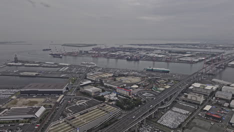 Nagoya-Japan-Aerial-v9-high-flyover-and-around-Kinjofuto,-Tobishima-capturing-bridges-spanning-across-the-waterway,-port-harbor-and-industrial-landscape---Shot-with-Mavic-3-Pro-Cine---October-2023