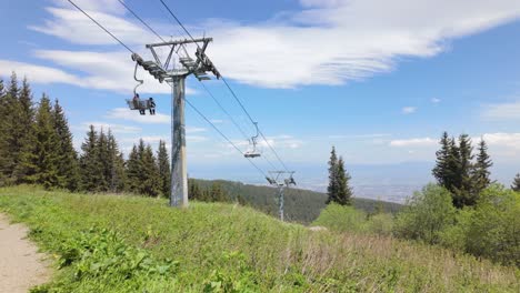 Father-and-son,-using-a-chairlift-in-a-mountain