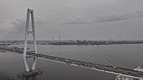 Nagoya-Japan-Aerial-v7-panning-views-flyover-the-port-capturing-traffic-on-Meiko-Chuo-Bridge,-Tokaimachi-and-Shiomicho-industrial-sector-on-an-overcast-day---Shot-with-Mavic-3-Pro-Cine---October-2023