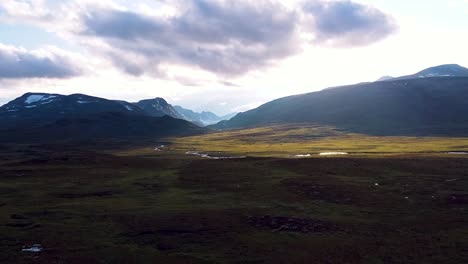 Drone-footage-capturing-a-breathtaking-sunset-over-the-Norwegian-mountains,-showcasing-stunning-landscapes-and-dramatic-skies