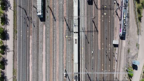 Drone-Descends-as-Trains-Move-Back-and-Forth-in-Train-Depot