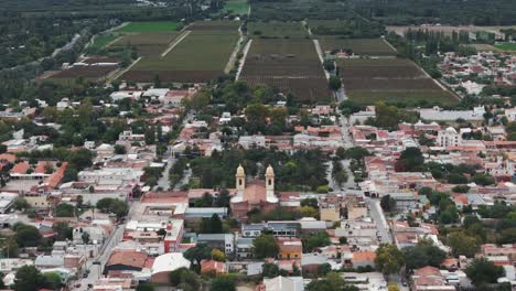 Aerial-drone-shot-of-cafayate-salta-town-in-Argentina-with-grapes-vineyard-in-background