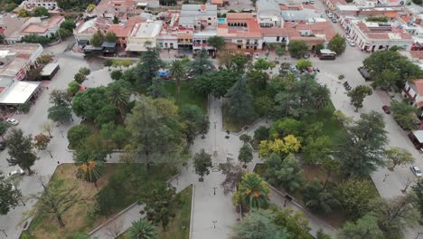 Top-down-drone-shot-of-a-green-recreational-park-surrounded-by-urban-houses-in-salta-cafayate-town-of-Argentina-south-america