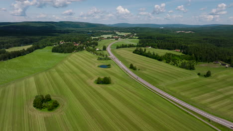 Drone-parallax-over-green-fields-in-Sweden-sunny-summer-day