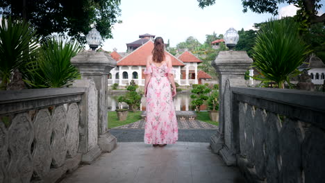 Female-travel-content-creator-in-summer-dress-explores-Bali-Ujung-Water-Palace