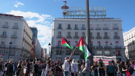 In-Madrid,-Spain,-protesters-brandish-Palestinian-flags-at-a-demonstration-advocating-for-an-end-to-arms-sales-to-Israel-by-the-Spanish-government-and-condemning-the-killing-of-Palestinians