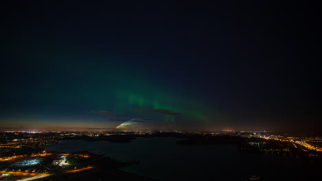 Timelapse-of-Northern-lights-dancing-above-the-Helsinki-cityscape,-autumn-night