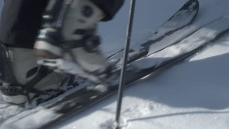 A-person-wearing-ski-boots-using-a-splitboard-in-snowy-Hokkaido,-Japan