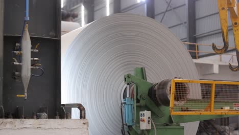 close-up-seen-in-paper-roll-A-big-roll-of-paper-is-being-prepared-from-inside-this-machine