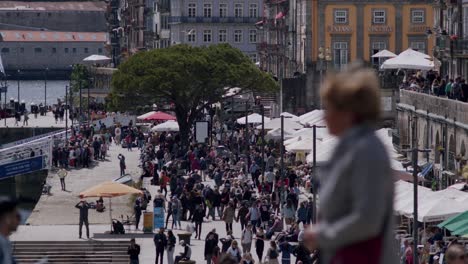 People-strolling-in-Porto-riverside,-ribeira,-on-a-sunny-day-slowmotion