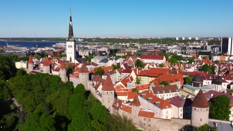 Aerial-Drone-Shot-Above-Walls-of-Tallinn,-Baltic-Sea-in-Background