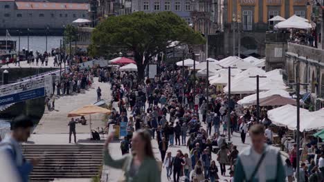 People-strolling-in-Porto-riverside,-ribeira,-on-a-sunny-day