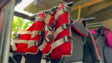 Life-jackets-hanging-for-water-activity,-close-up-view