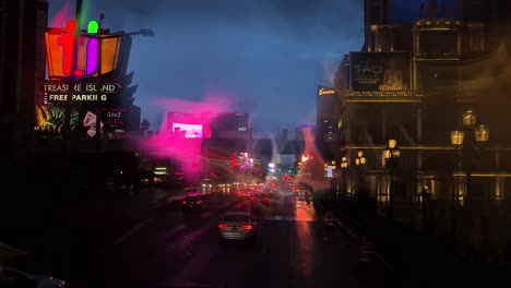 Las-Vegas-Strip-on-Rainy-Night,-Raindrops-on-Windshield-With-Abstract-Reflections,-Nevada-USA