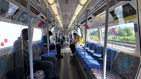 Passengers-seated-in-a-Jubilee-line-train-carriage-in-London,-conveying-the-concept-of-urban-commuting