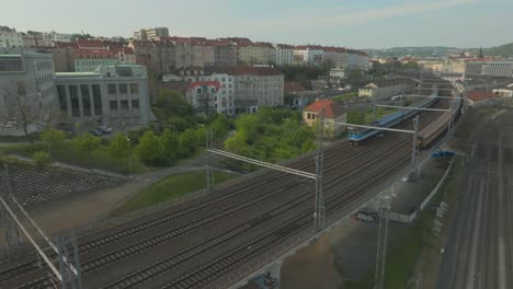 Drone-of-Trains-coming-and-going-from-Prague-Main-Railway-Station---Praha-Hlavní-Nádraží---Czech-Republic---Aerial-Pullback-Shot-,-Ceske-Drahy-CD---Czechia