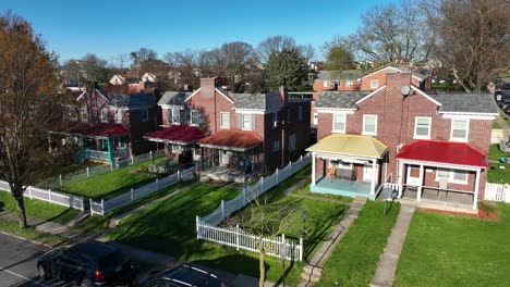 Aerial-view-of-a-residential-neighborhood-featuring-charming-brick-houses-with-colorful-roofs-and-well-maintained-lawns