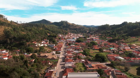 Delfim-Moreira,-Minas-Gerais,-Brasil,-Mostrando-La-Pintoresca-Ciudad-Rodeada-De-Exuberantes-Colinas,-Vista-Aérea.