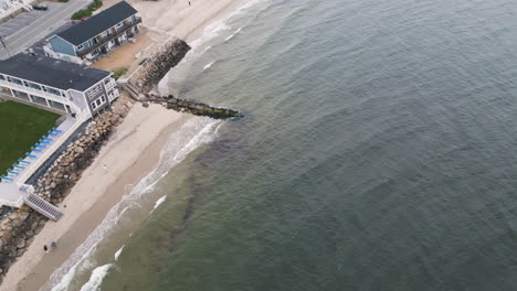 Aerial-flyover-jetty-and-sandy-beach-with-promenade-on-Nantucket-Island