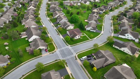 Aerial-view-of-a-picturesque-suburban-neighborhood-featuring-well-manicured-lawns,-neatly-arranged-houses,-and-intersecting-streets