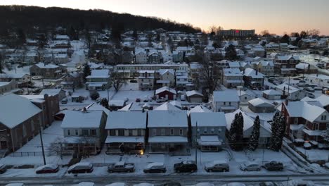 Twilight-descends-over-a-snowy-neighborhood-with-rows-of-tightly-packed-houses,-creating-a-quiet-winter-scene