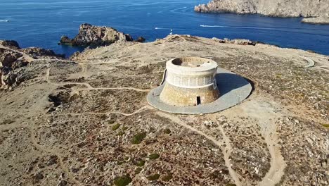 Aerial-parallax,-Fornells-Fortress,-coastal-island-attraction-destination