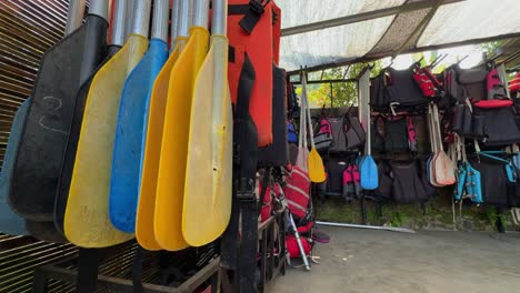 Life-jackets-and-boat-paddles-stored-for-boating-activities,-close-up