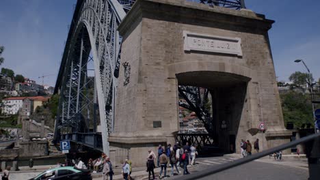 Tourists-entering-and-leaving-the-lower-deck-of-Dom-Luís-I-Bridge-in-Porto-on-a-sunny-day