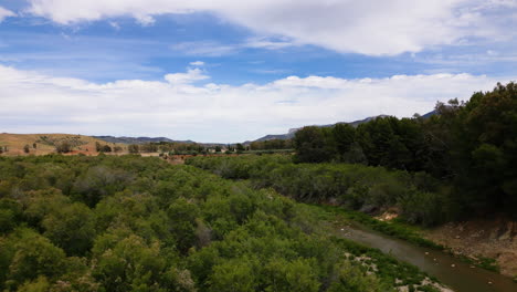 Estepona-mountain-landscape-with-river-on-windy-day,-aerial-drone-view