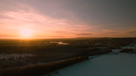 Beautiful-sunset-with-sun-placed-to-the-left-in-frame,-drone-push-out-aerial