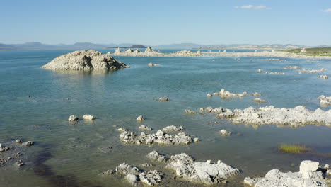 Hovering-above-Mono-Lake-with-tufa-formations-in-water,-located-in-California,-USA