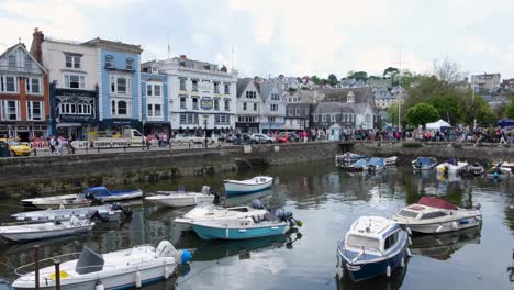 View-overlooking-Dartmouth-town-harbour,-shops,-restaurants-and-hotels-with-crowds-of-people-visiting-popular-English-holiday-destination-in-Devon,-England-UK