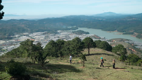 Lang-Biang-Mountain-View-on-Da-Lat-Countryside-Farmlands-and-Pine-Forests-by-Lake,-Tourists-Hike-Walking-in-Langbiang-Park-Trails-Enjoying-Rolling-Hills,-and-Captivating-Landscapes