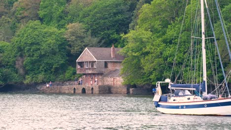 Historical-Greenway-boathouse-alongside-the-River-Dart-in-popular-English-holiday-destination-of-Dartmouth-in-Devon,-England-UK