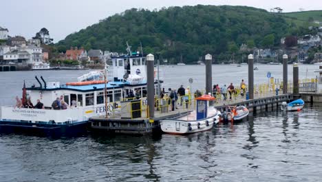 Crowd-of-people,-tourist-and-visitors,-arriving-off-River-Dart-ferry-at-popular-English-holiday-destination-of-Dartmouth,-Devon,-England-UK