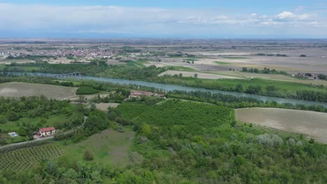 aerial-panorama-of-the-rustic-expanse-of-farmland-surrounding-the-town-of-Camino,-in-Alessandria,-Piedmont,-Italy