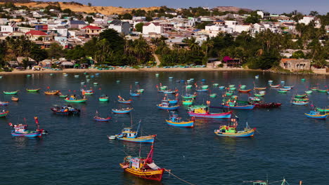 Colorful-Fishing-Boats-Anchored-Along-Mui-Ne-Beach,-Phan-Thiet,-Vietnam