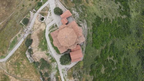 Aerial-shot-of-Jvari-church-Mtskheta-Georgia-river-city-mountains-meadows-forest