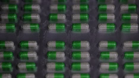 capsules-are-seen-ready-and-moving-to-the-packaging-line,-safety-first-concept