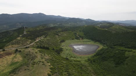 Aerial-shot-of-Jvari-church-Mtskheta-Georgia-river-city-mountains-meadows-forest-lake