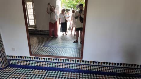 Couple-pose-in-the-mirror-of-touristic-attraction-riad-in-Marrakesh-Morocco