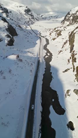 Van-going-through-a-valley-road-on-a-snowy-hills