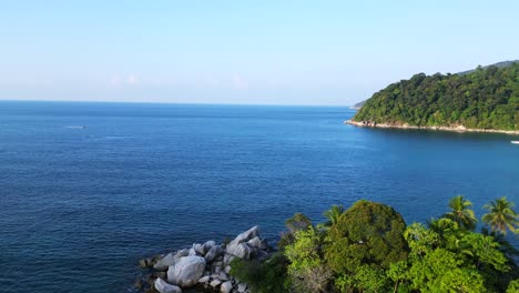 Best-aerial-view-flight-of-a-Hut-on-a-tropical-Sole-peninsula-with-turquoise-water-and-lush-green-vegetation