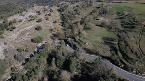 The-scenic-tavertet-region-in-barcelona-with-winding-roads-and-lush-greenery,-aerial-view