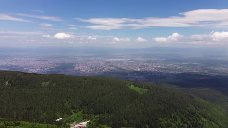 Drone-flying-high-up-in-Vitosha-mountain,-with-Sofia-city-in-the-background